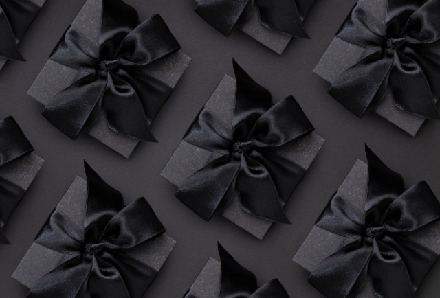 Gifts wrapped in black wrapping paper and black bows
